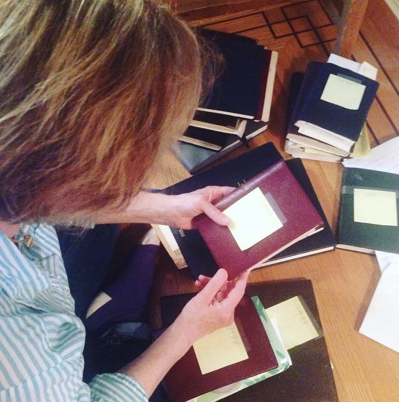 Holding one of ten diaries written by mom.