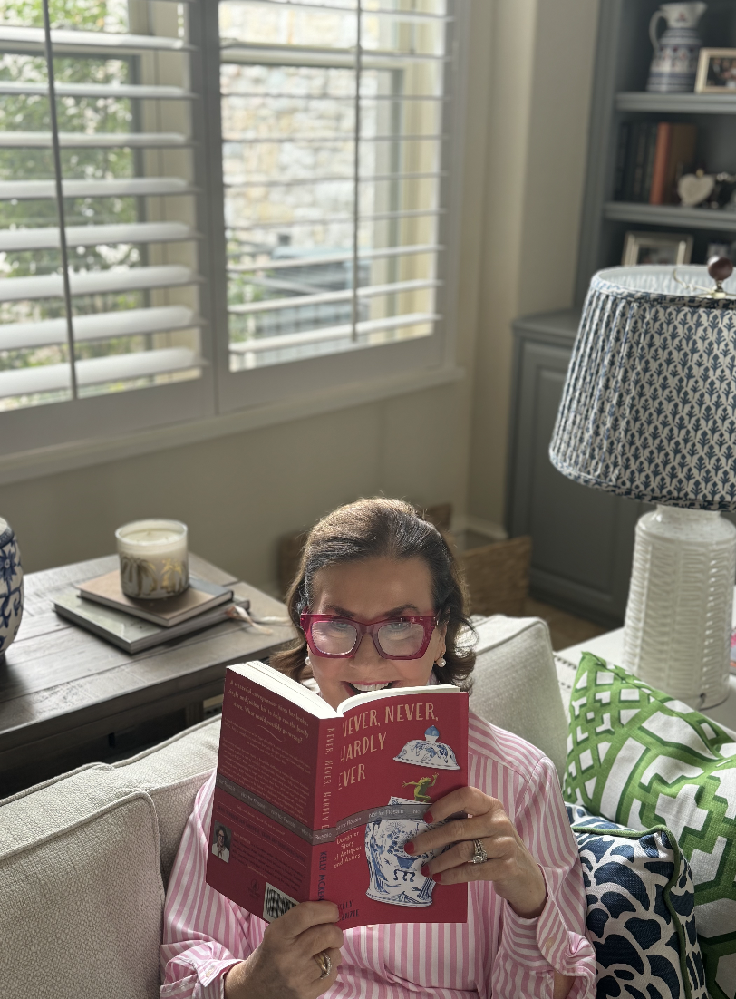 Woman in red glasses reading red paperback