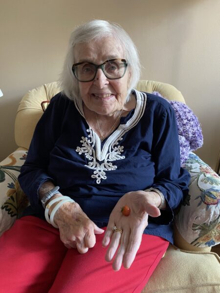 Elderly lady holding tiny tomato