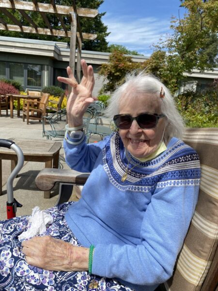 elderly woman waving