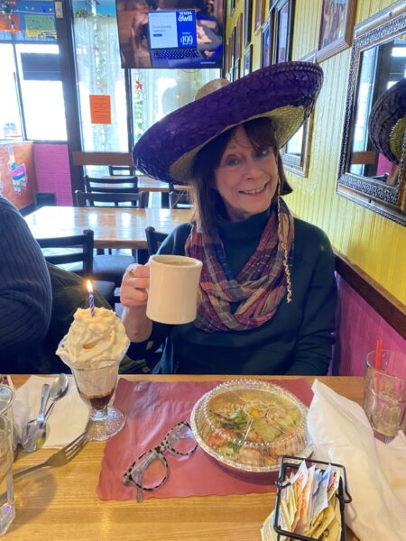 Gal in sombrero drinking coffee