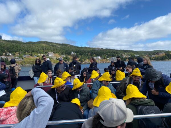 people wearing hello hats while riding boat